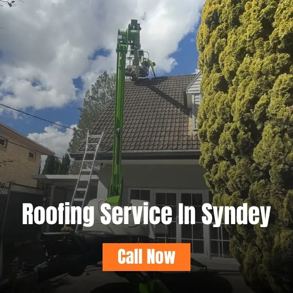 Roofing service in Sydney – worker on a green cherry picker lift servicing a tiled house roof